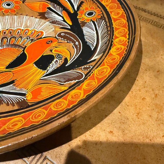 For your consideration, a decorative terracotta plate from Tonalá, Mexico, featuring hand-painted Mexican folk art....
