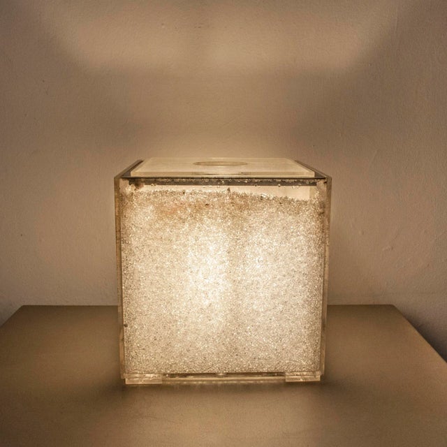 - Table lamp formed by a Acrylic Glass cube double wall in which small granules are inserted - in chromium-plated metal...