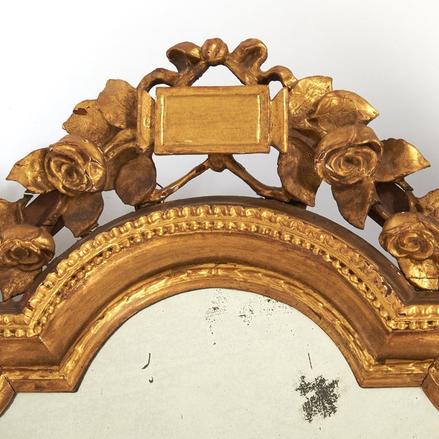 An elegant Louis XVI period carved giltwood mirror, France, late 18th century, retaining a beautifully aged surface and...