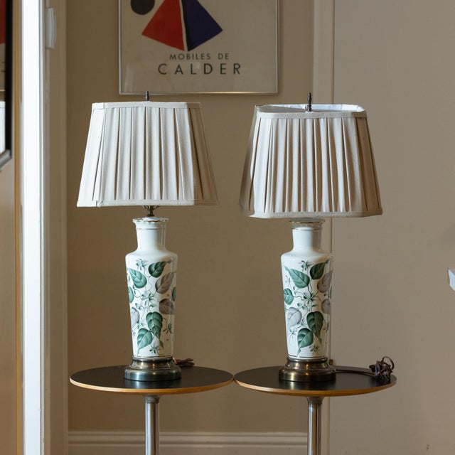 For your consideration, a matched pair of mid-century porcelain table lamps in exceptional condition. These elegant pieces...