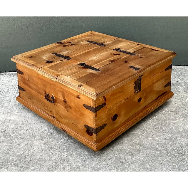 This vintage rustic storage coffee table is crafted from solid wood and accented with aged metal hardware, offering the...
