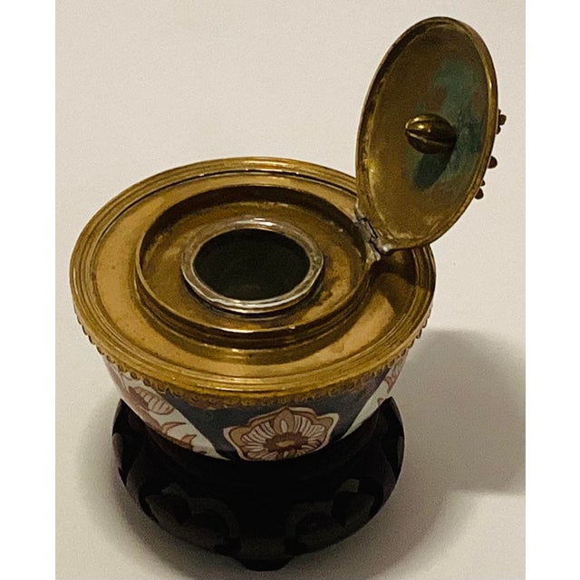 The brass rim, base ring. and the detailed lid with an acorn and leaf finial are done in the European ormulu style. It was...