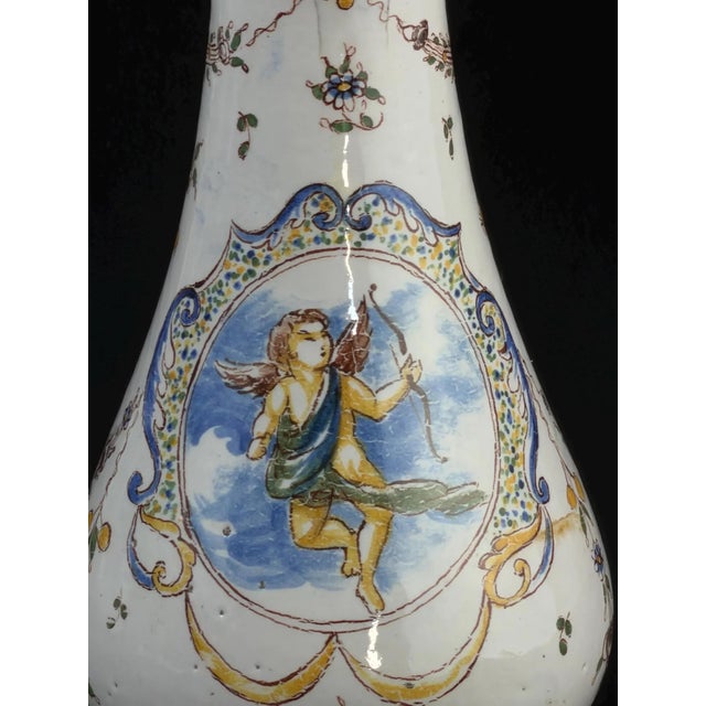 Rare early French faience vase dating to the late 17th – early 18th century, hand-painted with a charming cherub (putto)...