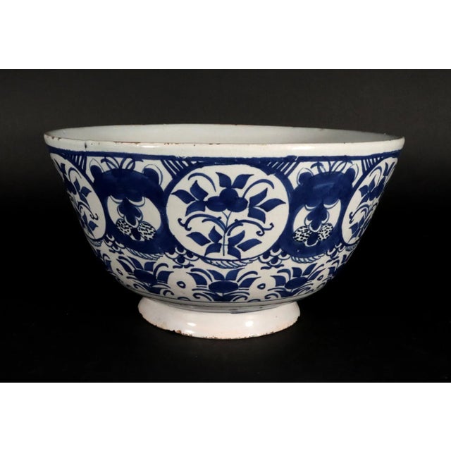 A wonderful Dutch Delft punch bowl from around 1720, painted in that deep, inky cobalt that made Delft famous, on a soft...
