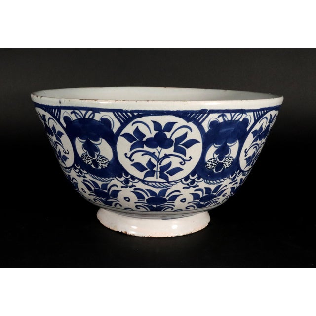 Dutch Delft Blue & White Botanical Bowl, Circa 1720 The high-sided Dutch Delft pottery blue and white bowl with a plain...
