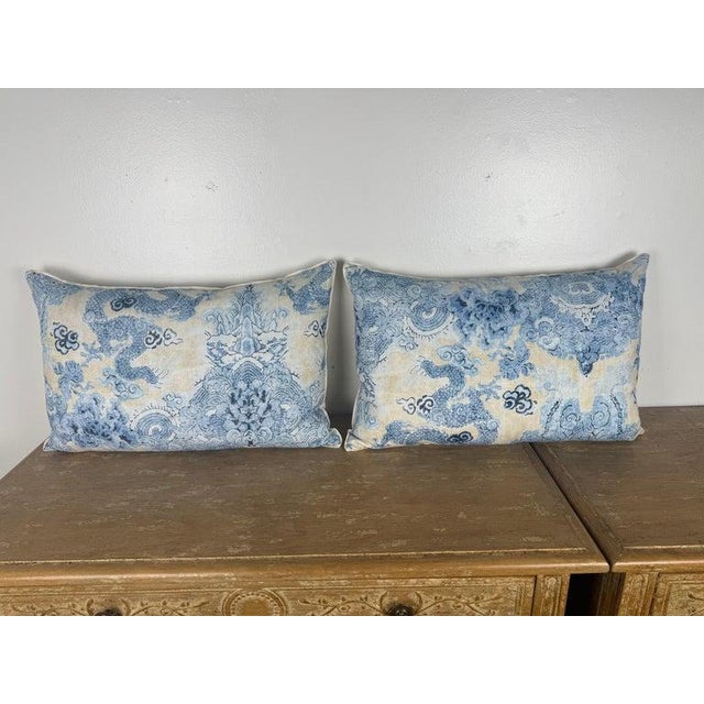 Elegant pair of decorative pillows crafted from printed linen depicting stylized mythical dragons amidst scrolling clouds,...