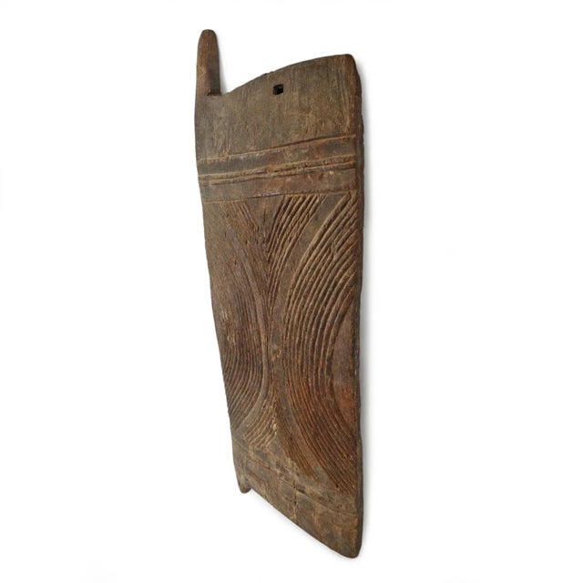 Old hand-carved Igbo grain door from southeastern Nigeria featuring a beautifully worn dark patina and deeply incised...