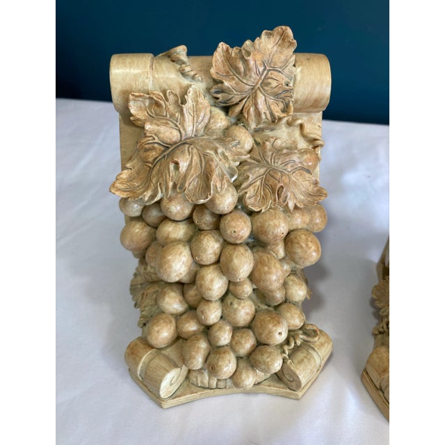 Offered is a striking pair of vintage bookends featuring sculpted grape clusters and leafy scrollwork, evoking the warm...