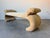 A bold and sculptural 1980s Postmodern upholstered bench in the Parsons style, featuring dramatically curled ends that...