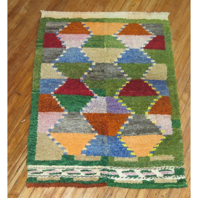 A vintage Turkish Tulu rug resembling Scandinavian Kilims. Geometric design throughout. Lots of different colors. We are...