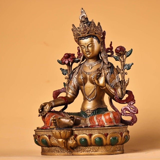 This is a finely crafted antique gilt bronze sculpture of Green Tara, a revered female Bodhisattva in Tibetan Buddhism...