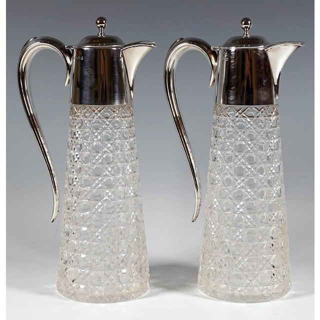 Two edward vii clear glass carafes with a conical body, elaborate steinel and octagonal cut on the outer wall, finely...
