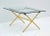 Superb French Jacques Adnet Glass Coffee Table features a polished folding Brass X Base in Faux Bamboo with saddle...