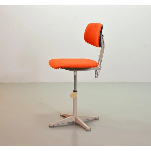 Authentic Ahrend De Cirkel Industrial Grey Steel Desk Chair from the 1950s. The grey frame is upholstered with a orange...