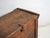 This antique carved trunk in pine wood features a flat geometric carving with diamond and stylised branch motifs covering...