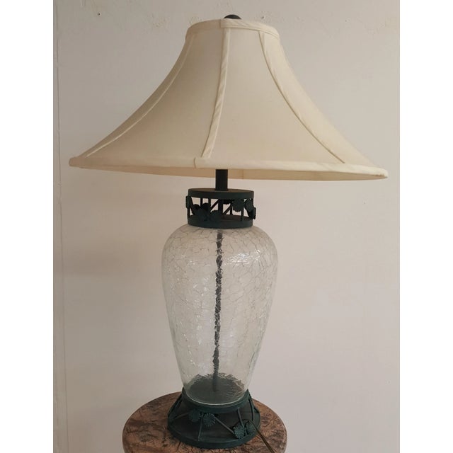 Showroom sample made by Distinguished Designs. Glass has rippled effect. The metal is bronze patina in a greenish tone....