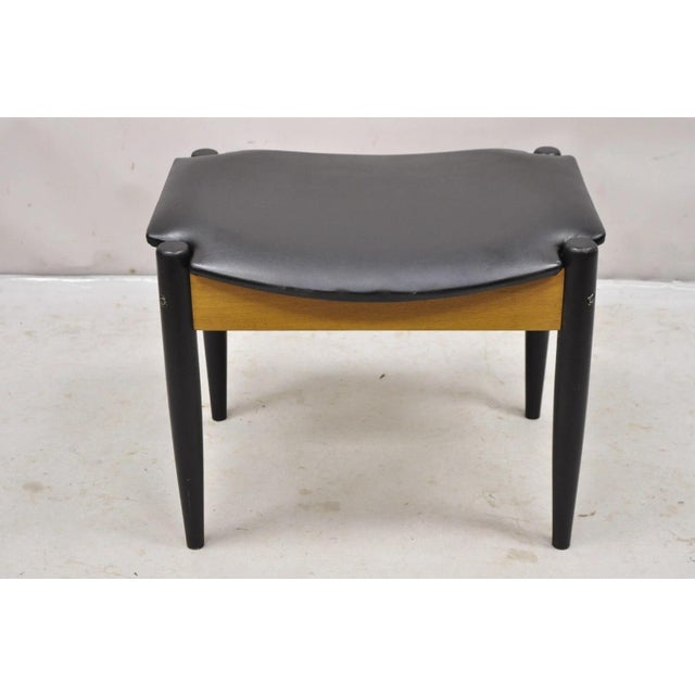 Norco Mid Century Modern Sculpted Footstool Ottoman with Tapered Legs and Black Vinyl Seat Age: Mid 20th Century...
