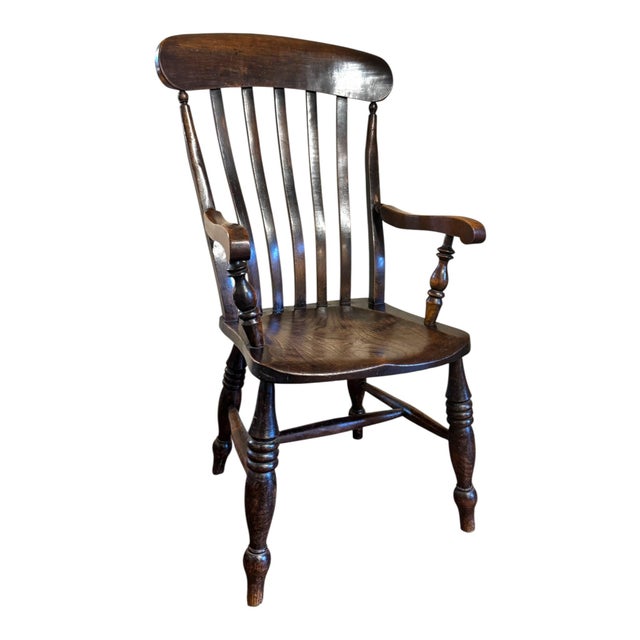 A handsome late 19th century English high-back Windsor armchair, dating to approximately 1880–1900. The chair has a...
