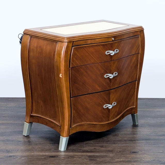 Bombe nightstand with chevron pattern drawer fronts, metal hardware and feet, pull-out tray, and marble top insert. Brand:...