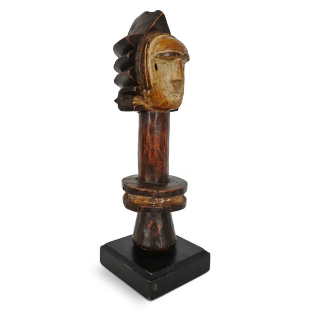 Original vintage carved wood figure post from Cross River, Nigeria. Displayed on black wood stand.