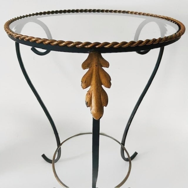 Beautiful vintage mid-century wrought iron plant table with glass and gold accents in the shape of acanthus leaves. It's a...
