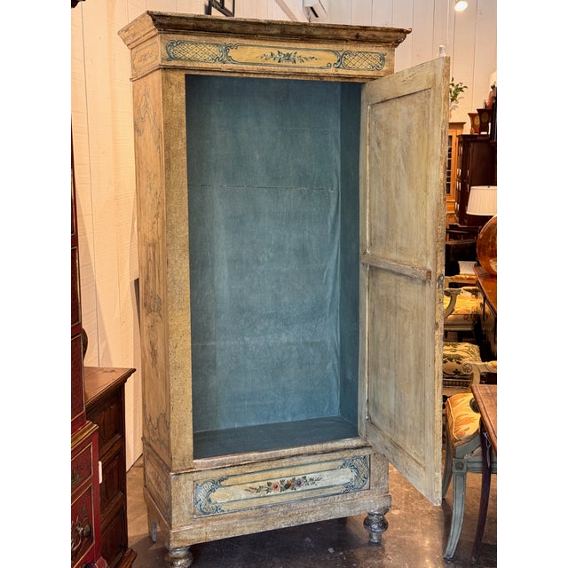 A 19th century Venetian painted armoire, the single door with a scene of classical ruins by the water inside blue rocaille...