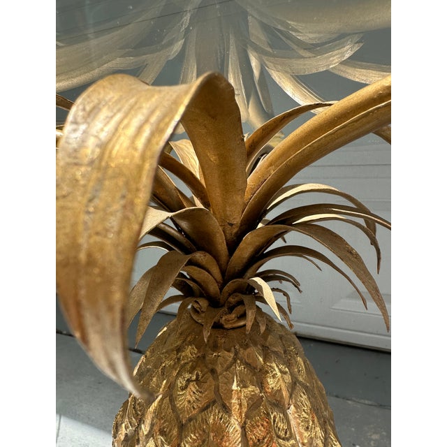 Pair of Mid-Century Italian Hollywood Regency Brass Pineapple Side Tables. The pair of side tables feature a highly...