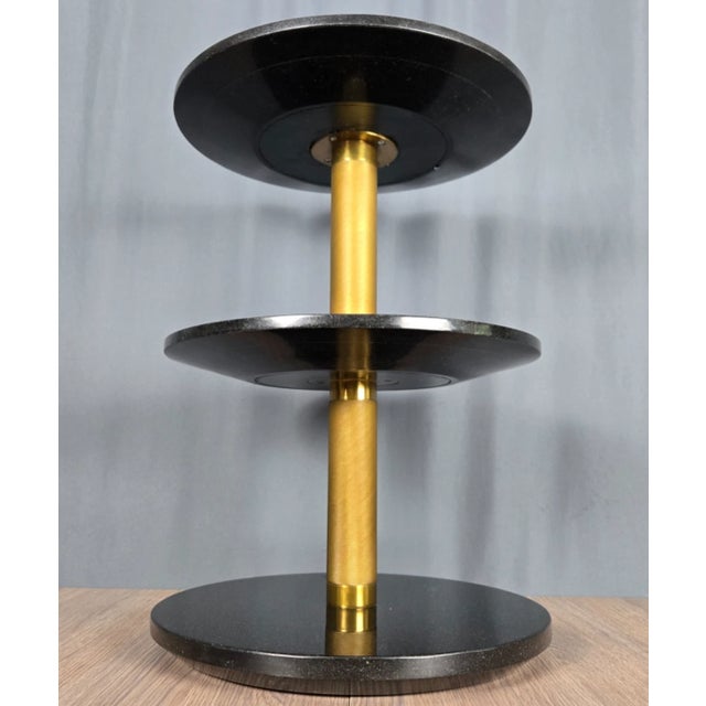 Ralph Lauren Wyman side table with three tiers of black marble and knurled brass column. Direct from a local estate, this...