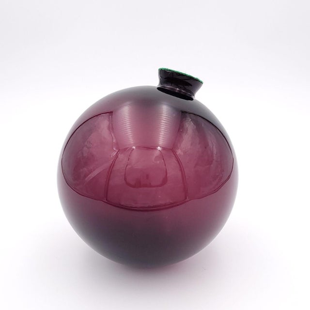 A purple witch ball, England circa 1870.