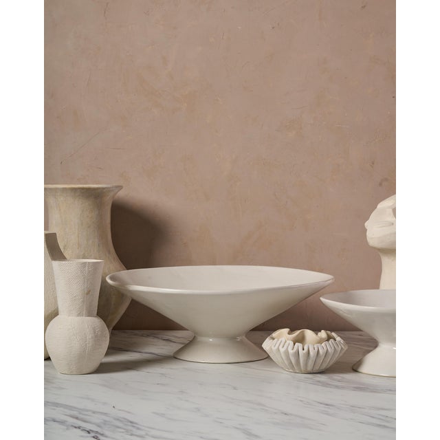 The Large Handcrafted Ceramic Pedestal Bowl by NPage Studio X Lostine is a sculptural decorative vessel that blends...