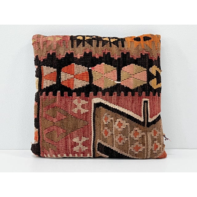 Handcrafted decorative pillow made from a vintage handwoven Turkish kilim, featuring rich tones of black, burgundy, rose,...