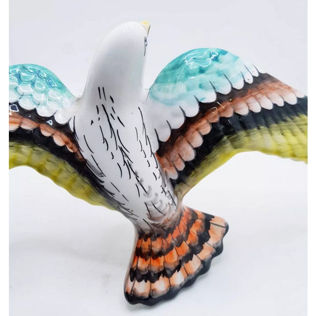 Large wall hanging ceramic bird with formed wings, as if in flight. Hand painted with fine strokes and a glossy glazed...