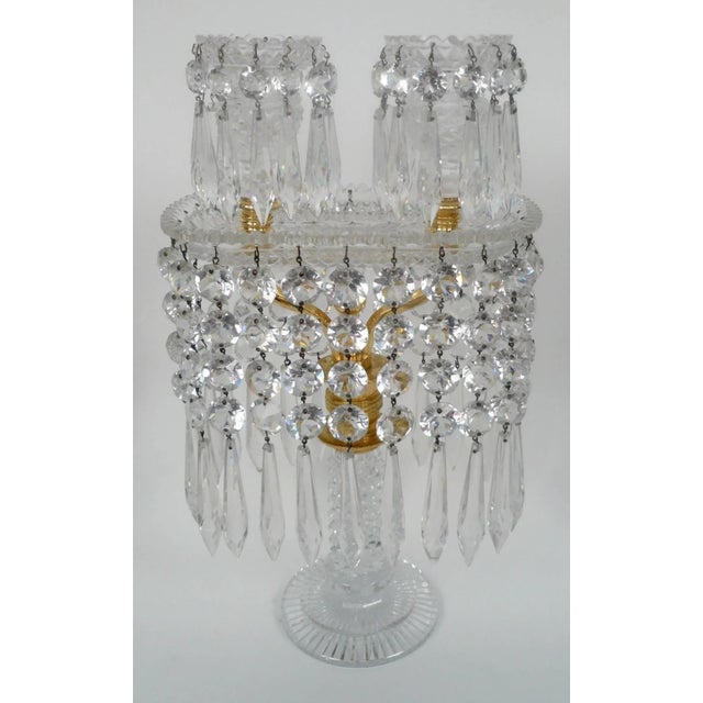 This fine pair of English neoclassical candelabra have diamond cut columns above circular star cut bases. The ormolu twin...