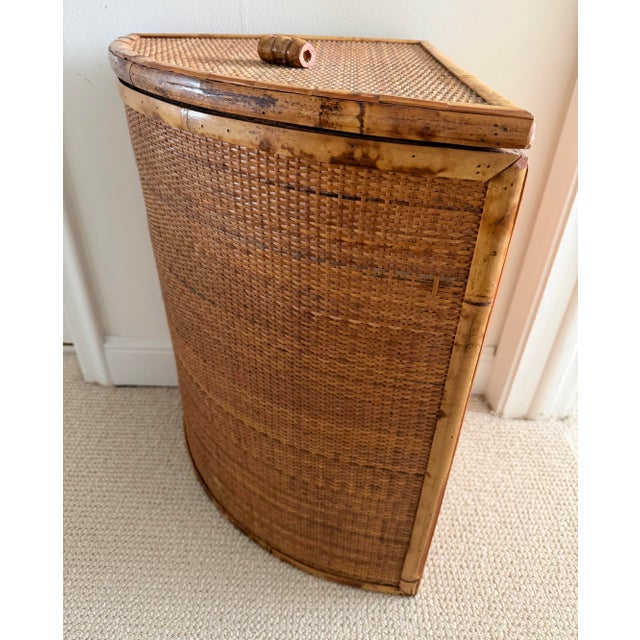 Vintage tortoise rattan corner laundry basket that features a hinged lid and a space saving triangular design