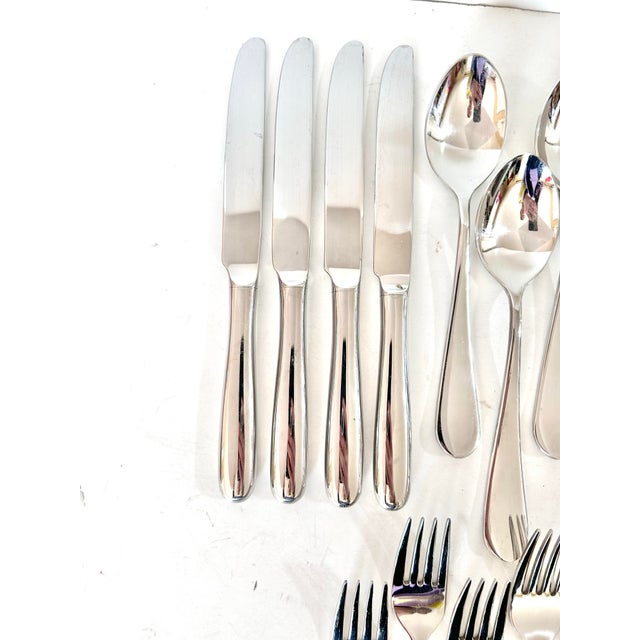 A polished Wallace stainless steel flatware set with simple teardrop-shaped handles and clean, versatile lines. The...