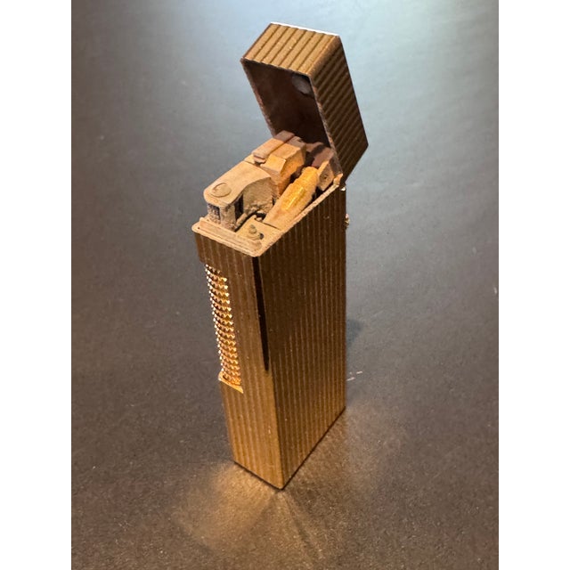 The Dunhill Rollagas pocket lighter is an iconic 1970s object that features elaborate design and engineering, and has...