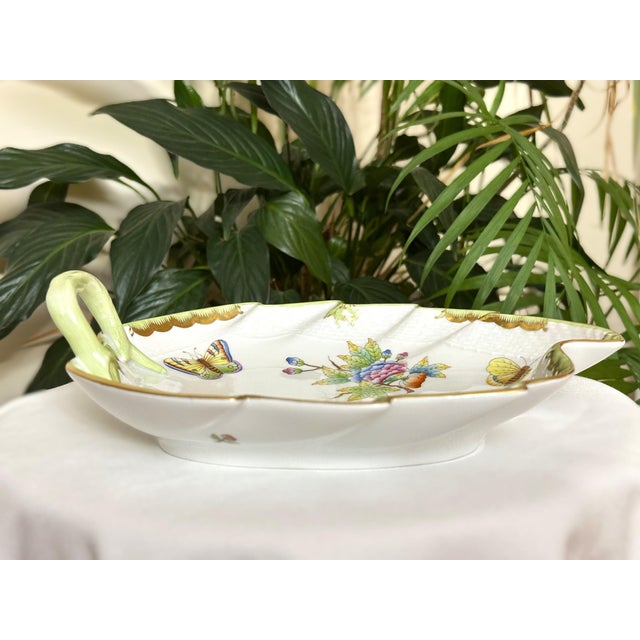 A Herend porcelain leaf-shaped dish in the "Queen Victoria" pattern (pattern code VBO 201). This piece features hand-...