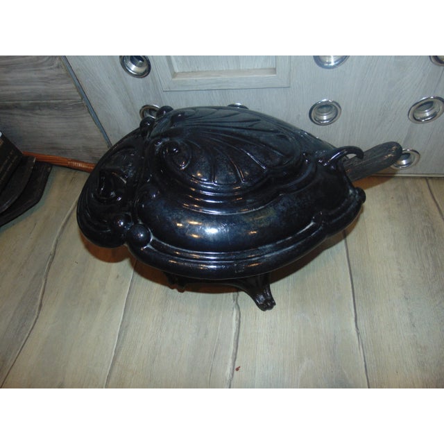 Pre-war enameled cast iron coal stove, brass fireplace blade, dimensions: width 46 cm, height 27 cm, depth 36 cm.