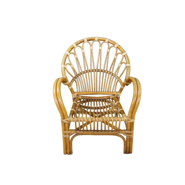 This pair of vintage mid-century bohemian bentwood rattan and bamboo armchairs features a striking, organic design...