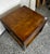 Super clean Lane table features a rich pecan finish, classic brass corner brackets, a central bail handle pull, and an...