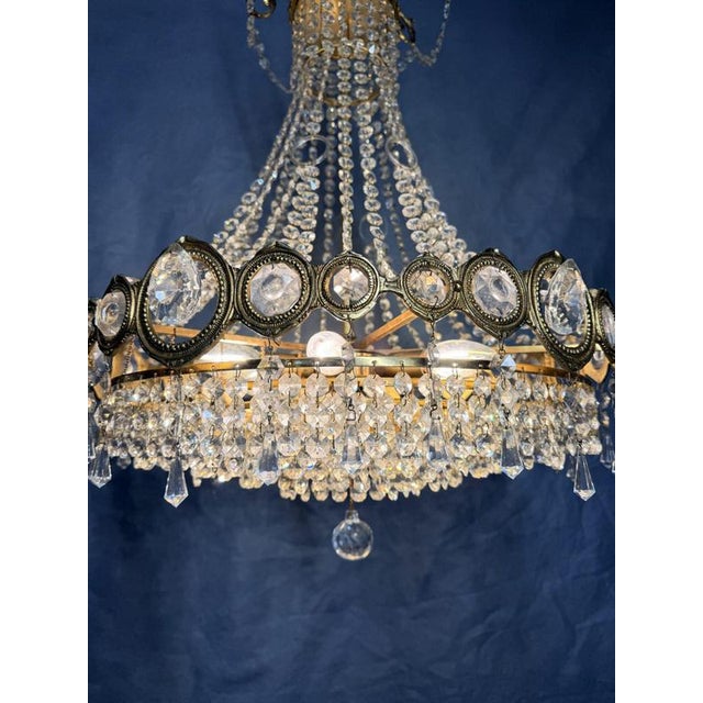 French 1960s cascading chandelier in a classic basket or sac du perle form. The brass crafted frame supports six light...