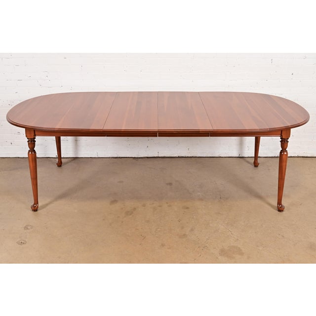 A gorgeous American Colonial or Queen Anne style solid cherry wood extension dining table By Ethan Allen USA, Circa 1970s...