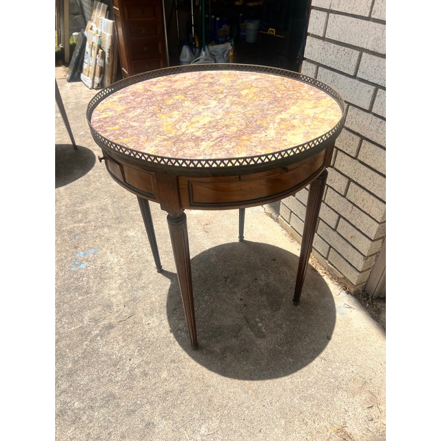 Elegant French Louis XVI side table crafted in walnut with a beautifully figured veneer. It features a single drawer, a...