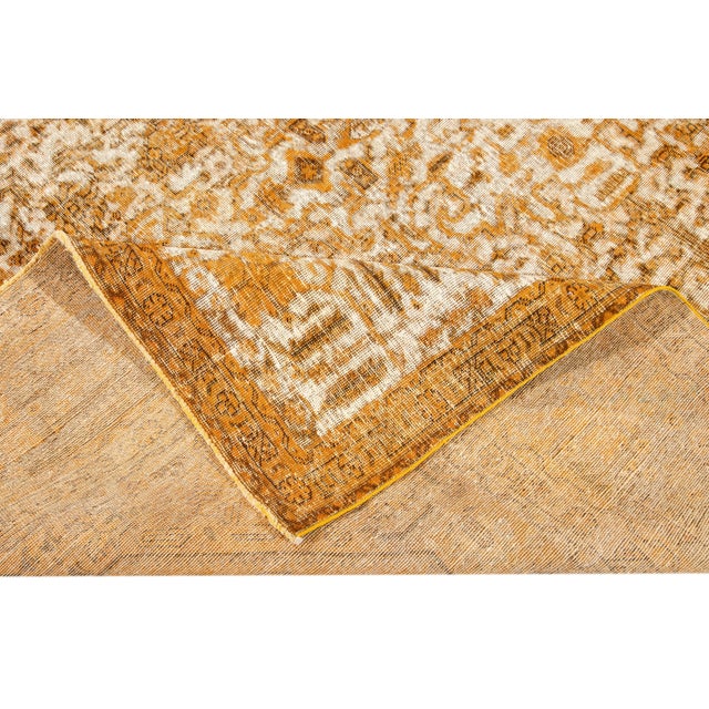 This beautiful rug with a floral design has a beige Wool field. This piece has been carefully distressed and dyed to give...