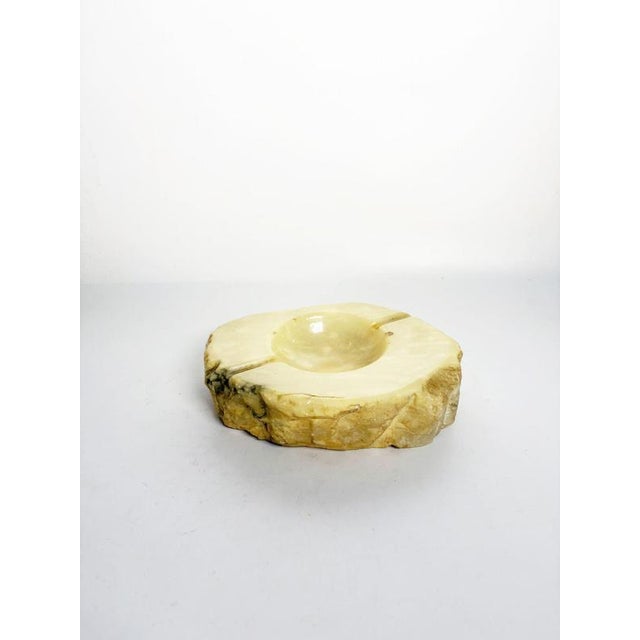 French onyx ashtray dating from the 1970s, carved from a solid piece of natural stone. It features an organic, irregular...