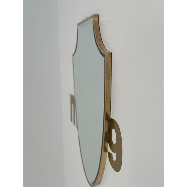 The Vintage Italian Brass Shield Mirror from the 1970s is a sleek and striking piece that epitomizes the bold design...