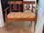 A small French settee in walnut, the flat crest rail above two openwork splats carved as lyres, each flanked by swans with...