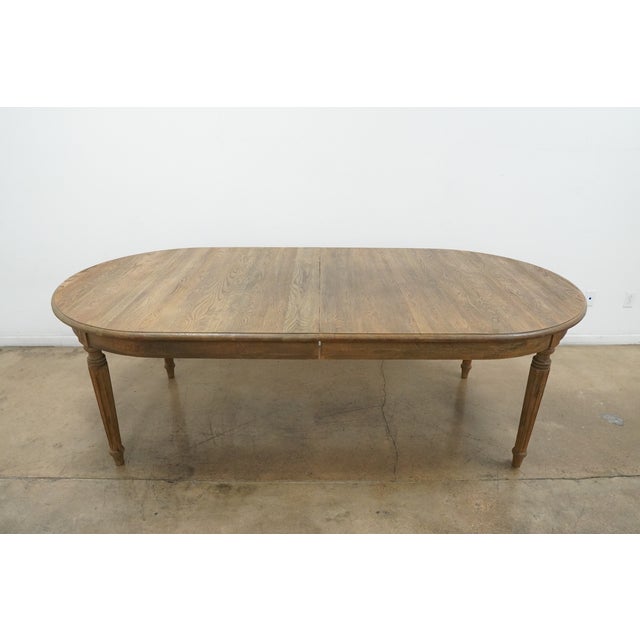 Inspired by 19th century French Empire design, this extension dining table is handcrafted from solid oak and fine veneers...