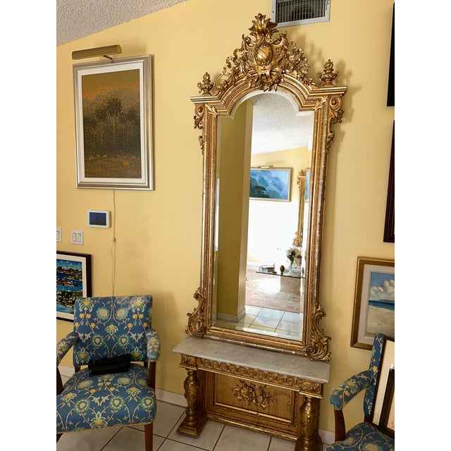Pair of Napoleon III giltwood pier mirrors circa third quarter 19th Century. The arched rectangular beveled mirrors within...