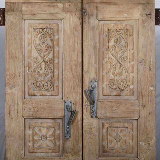 Antique Indian carved teakwood door, c. 1880–1900, carefully bleached to highlight its sculptural carvings and lighten the...